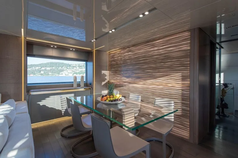 7 Seconds Yacht Photos Pics Luxurious dining area on 2015 Dreamline 26 yacht with glass table and scenic window view.