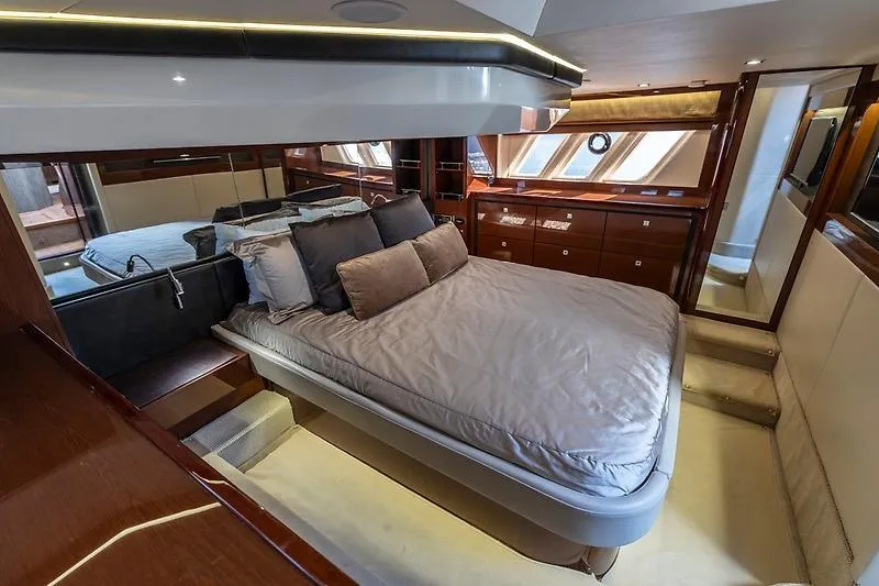 Caroline Kai Yacht Photos Pics Luxurious bedroom interior of 2016 Sea Ray 510 Fly yacht with elegant furnishings.
