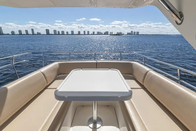 Caroline Kai Yacht Photos Pics Luxurious seating area on 2016 Sea Ray 510 Fly yacht overlooking ocean and skyline.