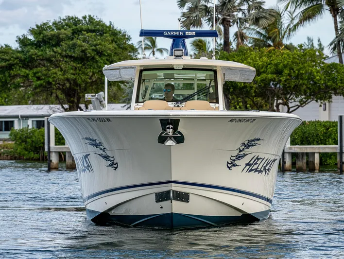  Yacht Photos Pics 2019 Scout 420 LXF boat on water, front view with trees in background.