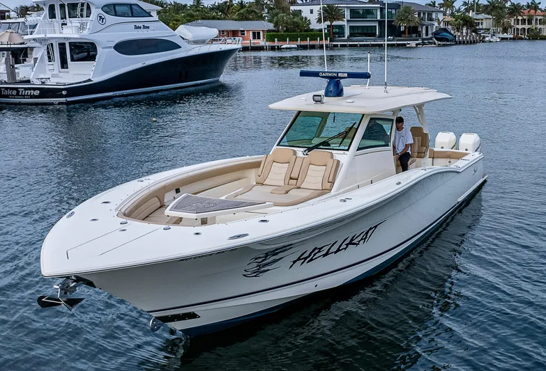  Yacht Photos Pics 2019 Scout 420 LXF boat named "Hellkat" cruising on a calm waterway.