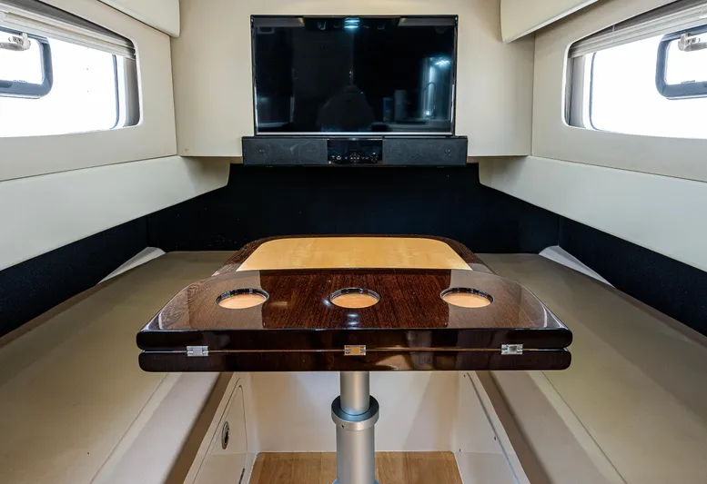 Yacht Photos Pics 2019 Scout 420 LXF cabin interior with table and TV, featuring modern design and comfort.