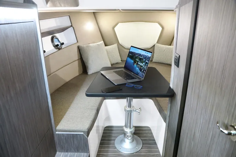  Yacht Photos Pics Interior of 2025 Ranieri NEXT 330 XL boat with laptop on table.