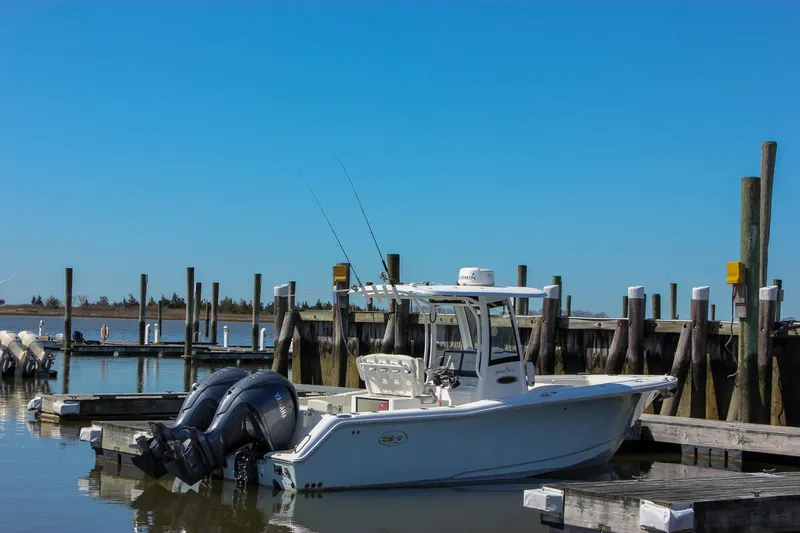  Yacht Photos Pics 2023 Sea Hunt Gamefish 27 with Coffin Box docked at a marina under clear blue skies.