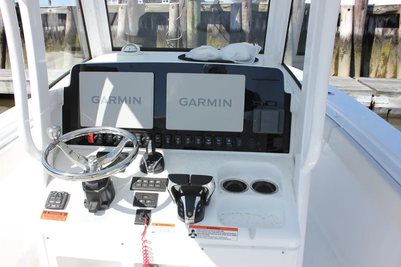  Yacht Photos Pics 2023 Sea Hunt Gamefish 27 dashboard with Garmin displays and steering wheel.