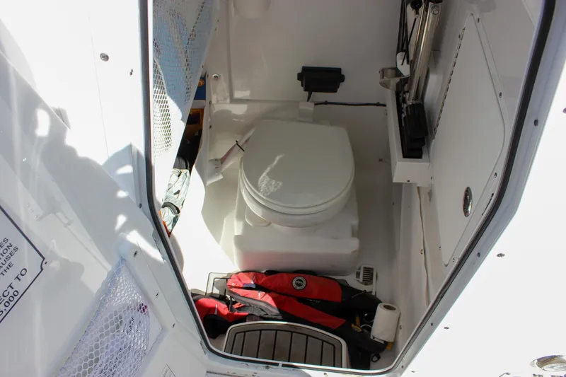  Yacht Photos Pics 2023 Sea Hunt Gamefish 27 interior with toilet and storage area.