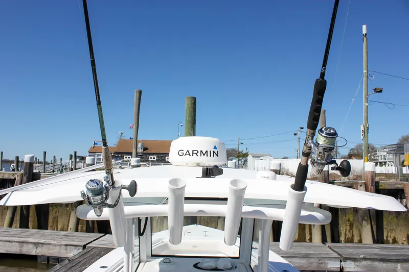  Yacht Photos Pics 2023 Sea Hunt Gamefish 27 with Coffin Box, featuring fishing rods and Garmin equipment at a dock.