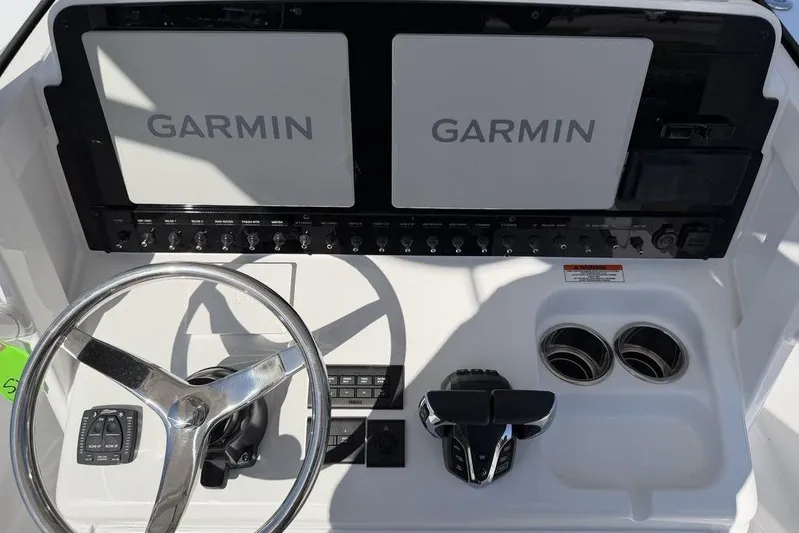  Yacht Photos Pics 2026 Sea Hunt Gamefish 27 dashboard with dual Garmin displays and steering wheel.