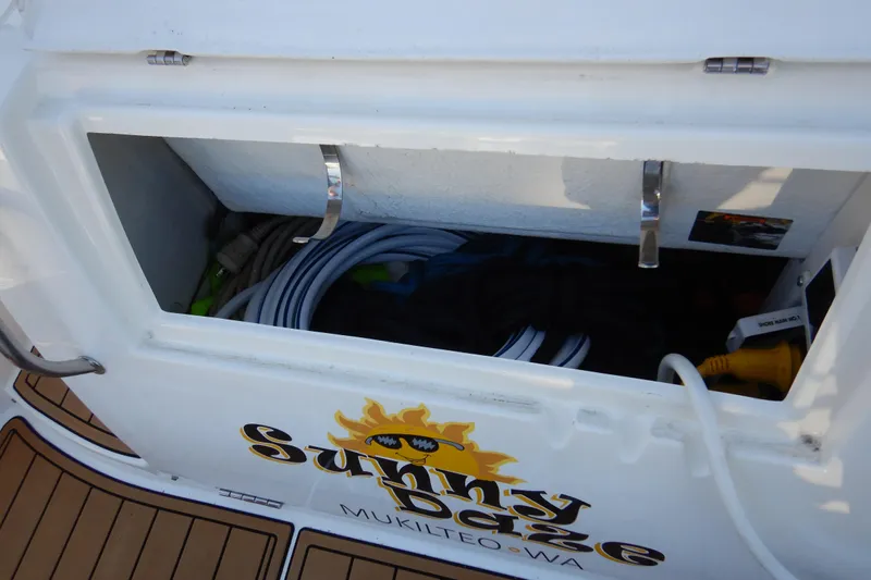 Sunny Daze Yacht Photos Pics Open storage compartment on 2007 Cruisers 340 Express boat with coiled hoses and equipment.