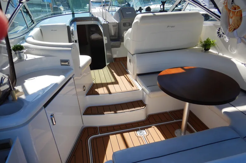 Sunny Daze Yacht Photos Pics Luxurious 2007 Cruisers 340 Express yacht interior with white seating and wooden flooring.