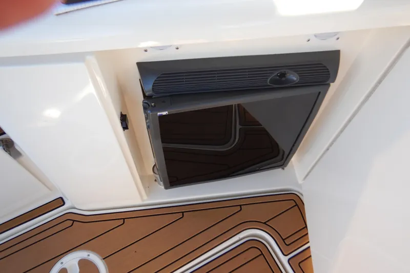 Sunny Daze Yacht Photos Pics 2007 Cruisers 340 Express boat interior with a built-in refrigerator and teak flooring.