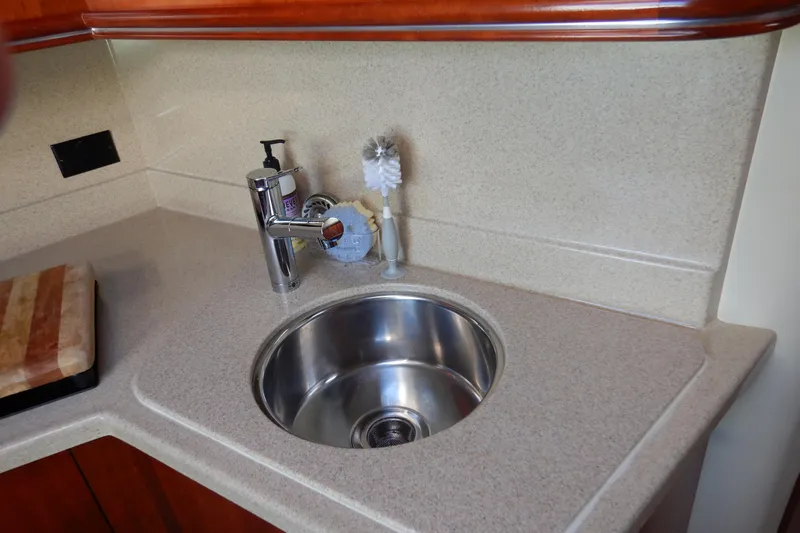 Sunny Daze Yacht Photos Pics 2007 Cruisers 340 Express yacht kitchen sink with countertop and faucet.