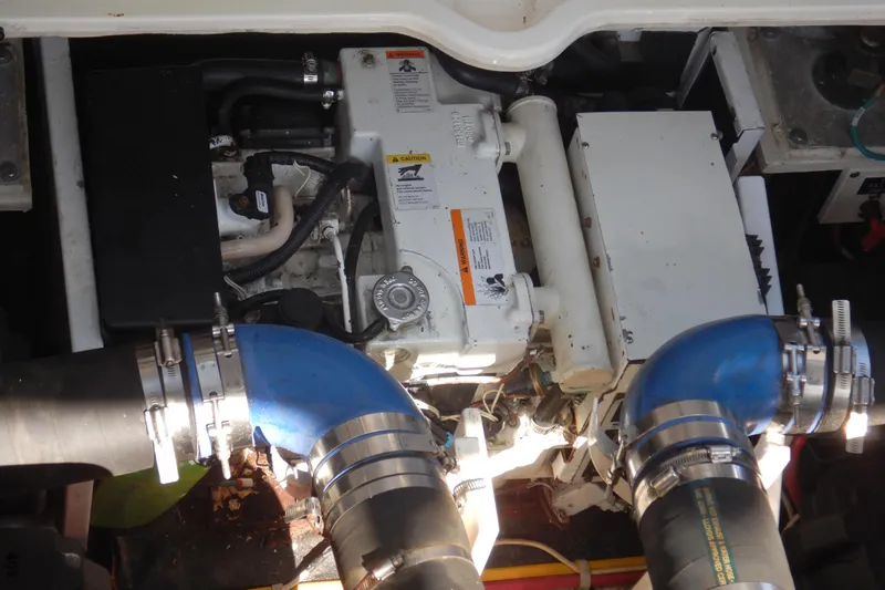Sunny Daze Yacht Photos Pics Engine compartment of a 2007 Cruisers 340 Express boat with visible hoses and components.