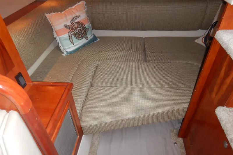 Sunny Daze Yacht Photos Pics 2007 Cruisers 340 Express cabin interior with cushioned seating and decorative turtle pillow.