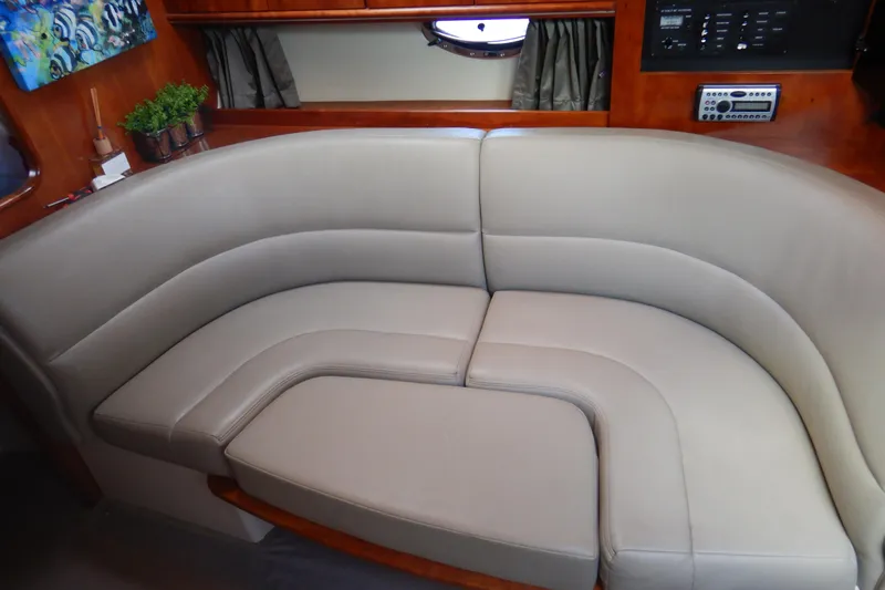 Sunny Daze Yacht Photos Pics 2007 Cruisers 340 Express yacht interior with curved beige seating and wooden accents.