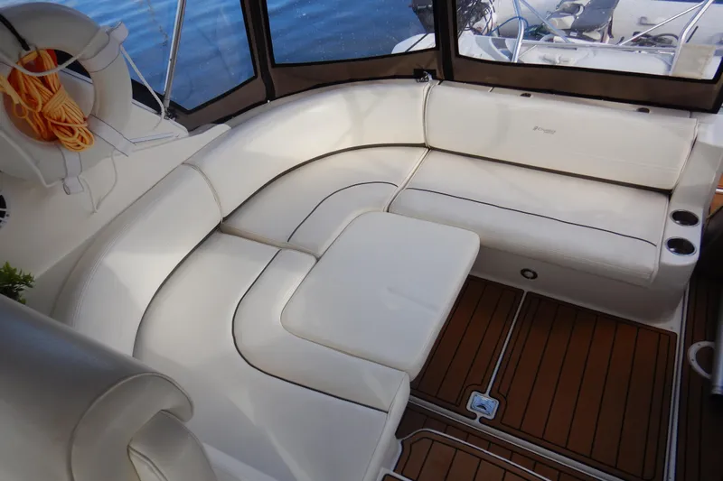 Sunny Daze Yacht Photos Pics 2007 Cruisers 340 Express boat interior with white seating and wooden flooring.