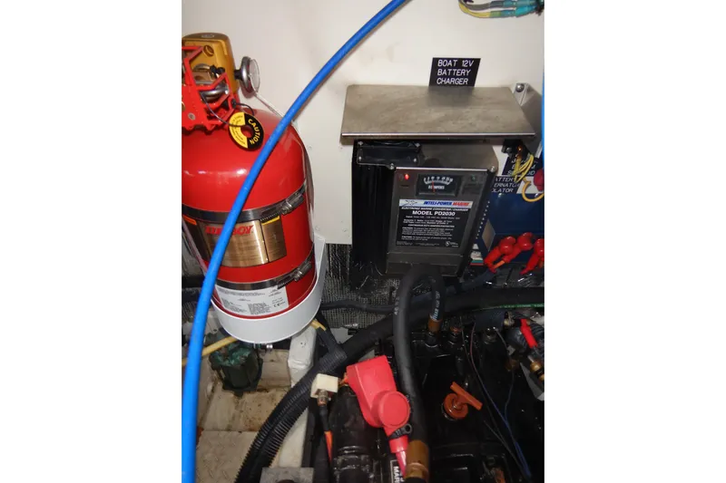 Sunny Daze Yacht Photos Pics 2007 Cruisers 340 Express engine room with fire extinguisher and 12V battery charger.