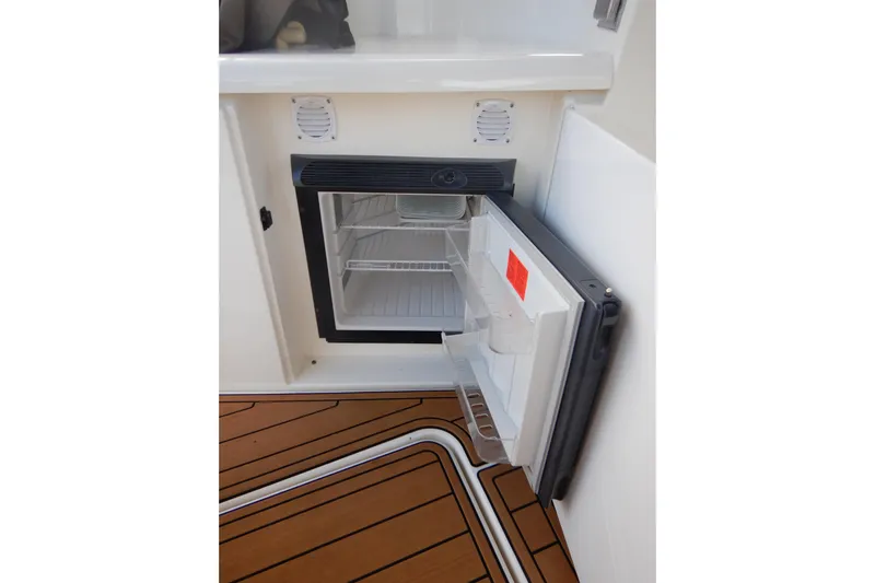 Sunny Daze Yacht Photos Pics Open mini fridge on 2007 Cruisers 340 Express boat with teak flooring.