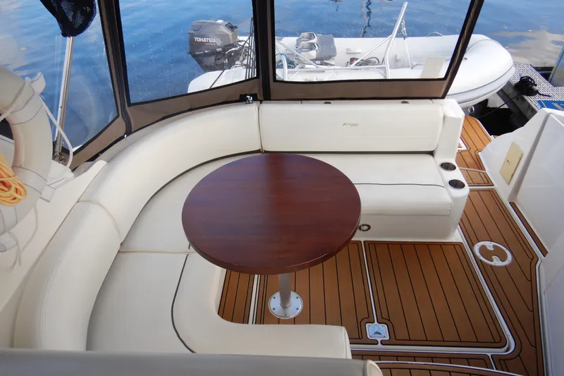 Sunny Daze Yacht Photos Pics 2007 Cruisers 340 Express yacht interior with seating and wooden table on deck.