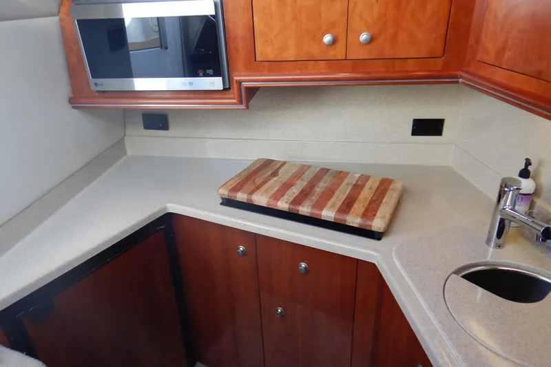 Sunny Daze Yacht Photos Pics 2007 Cruisers 340 Express yacht kitchen with microwave, cutting board, and sink.