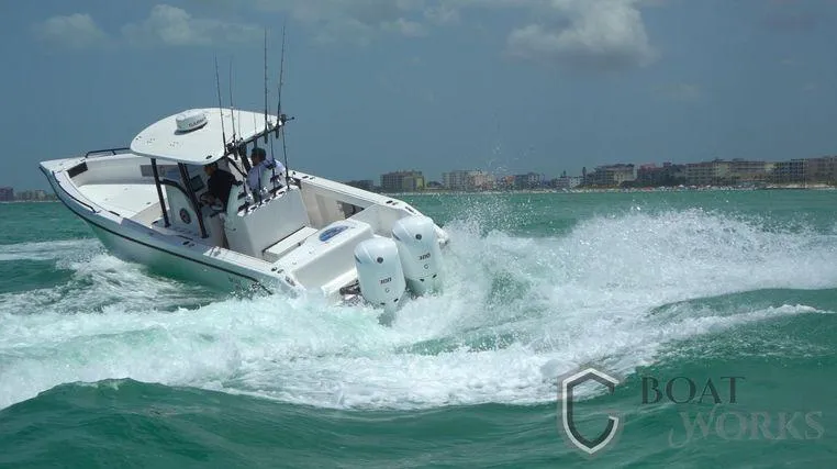  Yacht Photos Pics 2022 CG Boat Works 35 M-Series navigating choppy waters near a coastal city.
