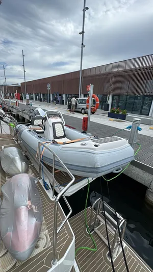 Plan C Yacht Photos Pics 2024 Leopard 53 Powercat docked with inflatable boat on deck, modern marina setting.