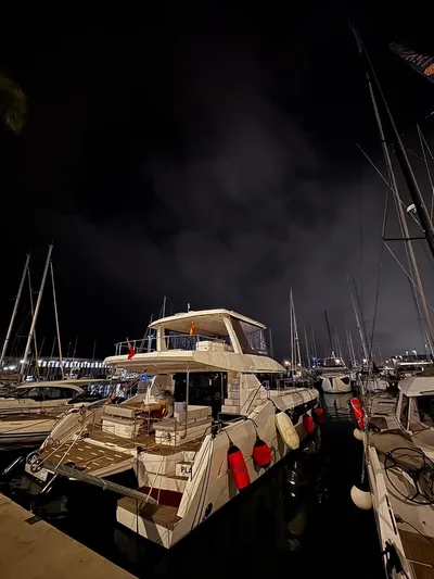 Plan C Yacht Photos Pics 2024 Leopard 53 Powercat docked at night, surrounded by other boats.