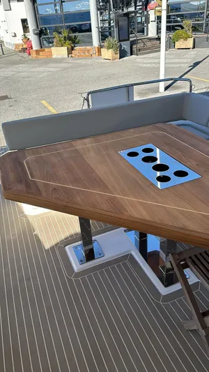 Plan C Yacht Photos Pics 2024 Leopard 53 Powercat deck with elegant wooden table and cup holders.