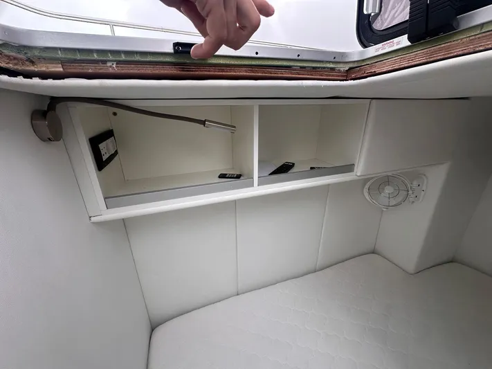 Plan C Yacht Photos Pics 2024 Leopard 53 Powercat interior storage with shelves and a light fixture.