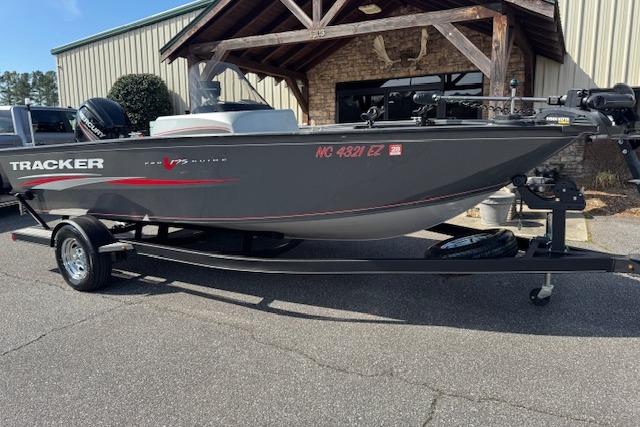 2018 Tracker Pro Guide V-175 SC boat on trailer outside a building.