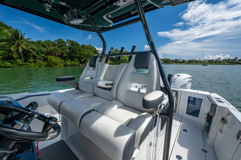 Aurora Yacht Photos Pics 2019 Blackfin 332 boat interior with luxurious seating, steering wheel, and scenic water view.