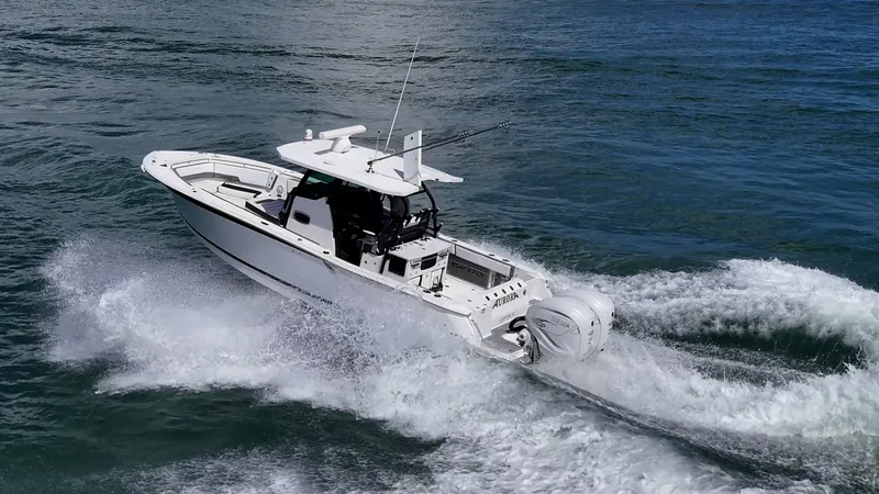 Aurora Yacht Photos Pics 2019 Blackfin 332 boat cruising on open water, creating a dynamic wake.