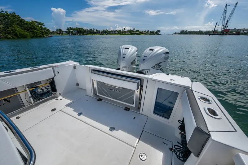 Aurora Yacht Photos Pics 2019 Blackfin 332 boat with dual Yamaha engines on a calm waterway.