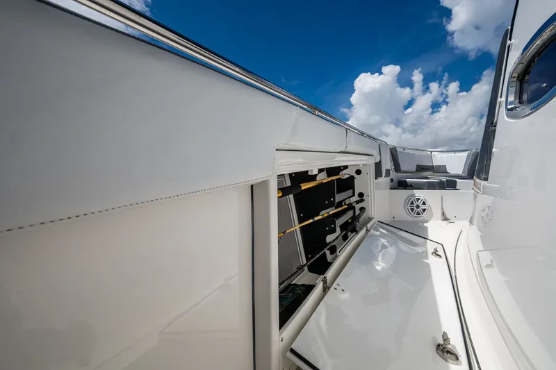 Aurora Yacht Photos Pics 2019 Blackfin 332 boat interior with rod storage, sleek design, and clear blue sky.