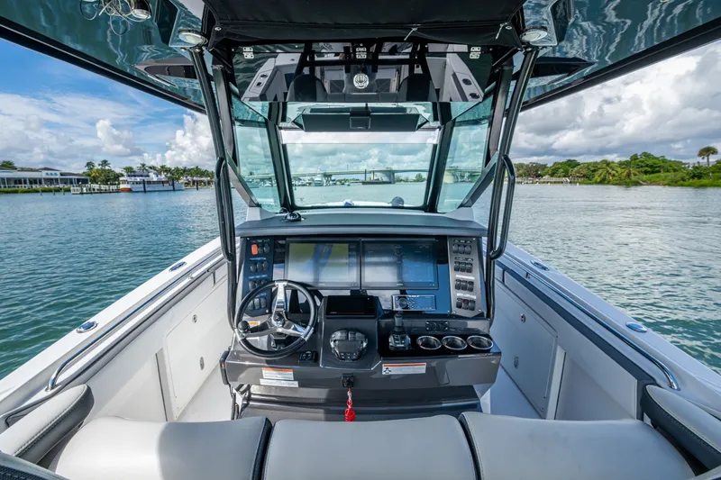 Aurora Yacht Photos Pics 2019 Blackfin 332 boat helm with modern controls and scenic water view.