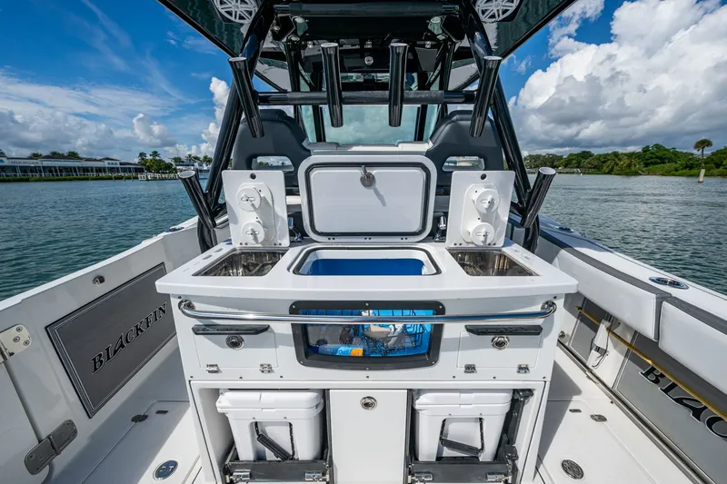 Aurora Yacht Photos Pics 2019 Blackfin 332 boat interior with fishing station, sink, and storage compartments.
