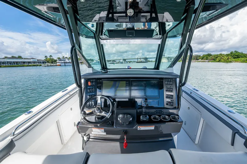 Aurora Yacht Photos Pics Helm of 2019 Blackfin 332 boat with modern controls and scenic water view.
