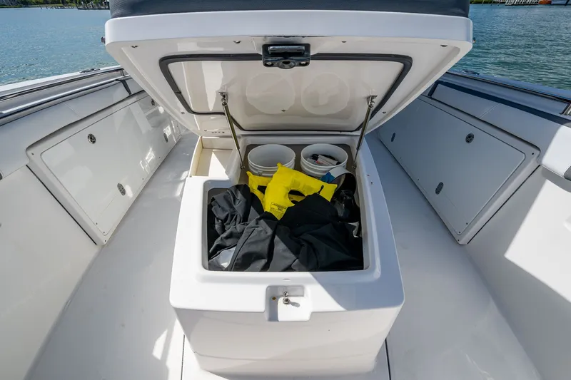 Aurora Yacht Photos Pics Open storage compartment on 2019 Blackfin 332 boat, containing gear and buckets.