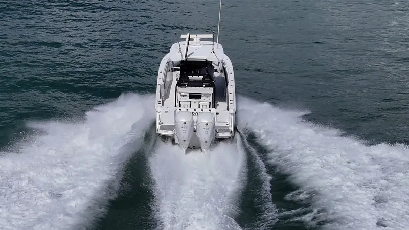 Aurora Yacht Photos Pics 2019 Blackfin 332 boat cruising on open water, rear view.