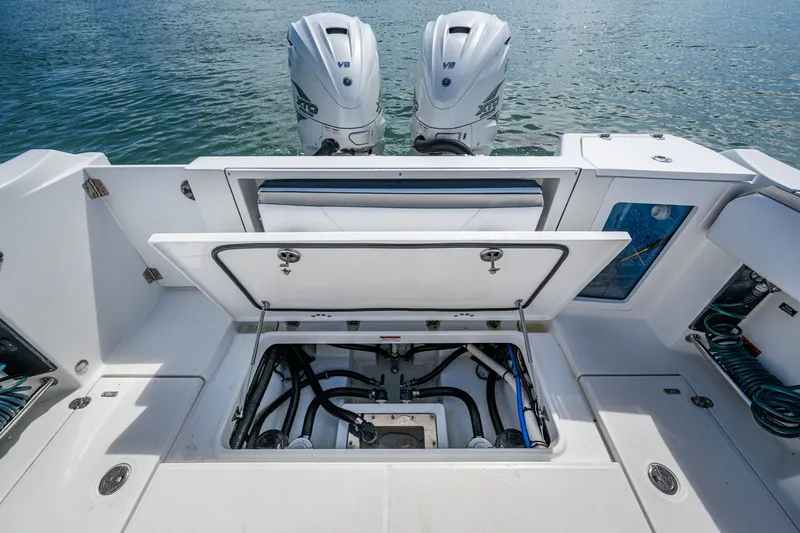 Aurora Yacht Photos Pics 2019 Blackfin 332 boat with open hatch, revealing engine compartment and dual outboard motors.