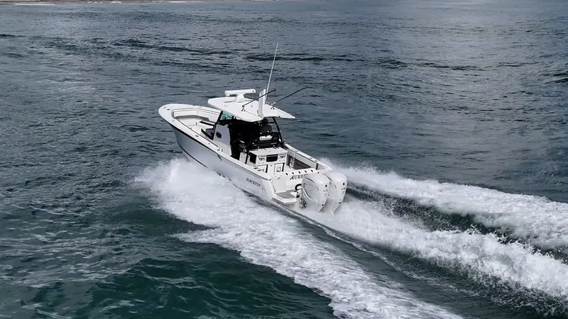 Aurora Yacht Photos Pics 2019 Blackfin 332 boat cruising on open water, creating a wake behind.