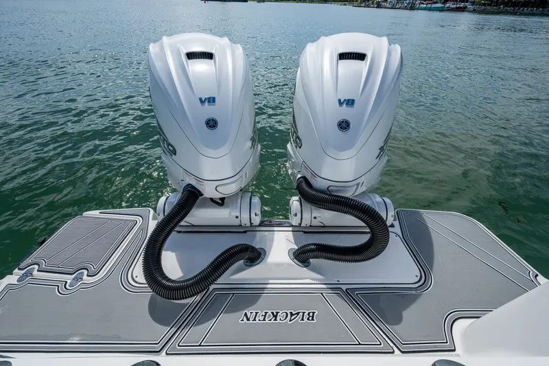 Aurora Yacht Photos Pics Twin V8 engines on a 2019 Blackfin 332 boat, docked on calm water.