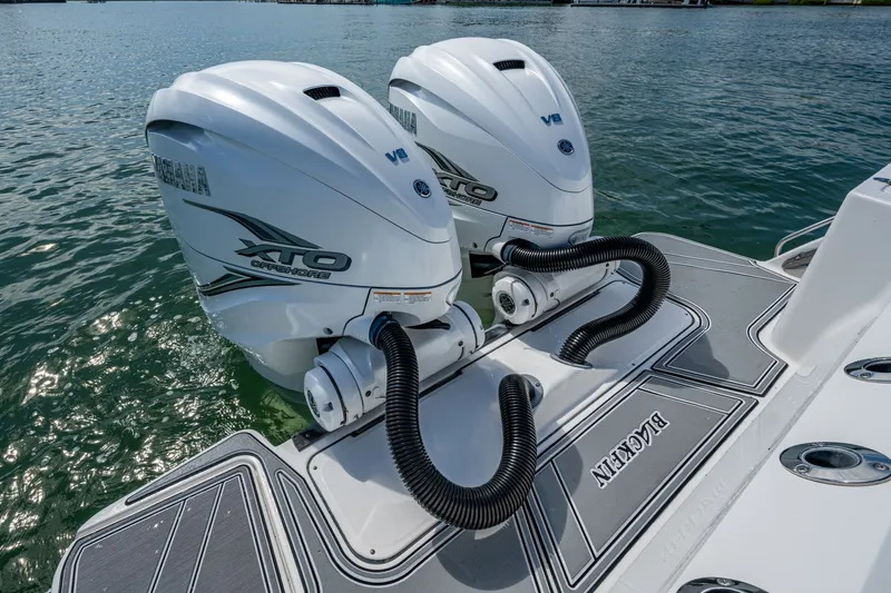 Aurora Yacht Photos Pics Twin Yamaha XTO V8 engines on a 2019 Blackfin 332 boat, docked on calm water.