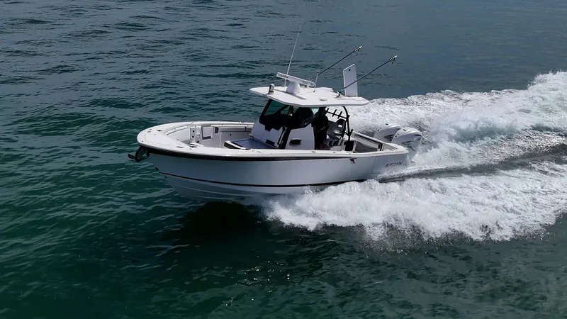 Aurora Yacht Photos Pics 2019 Blackfin 332 boat cruising on open water, creating a wake.