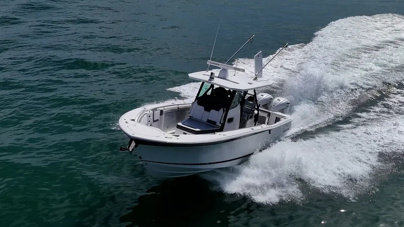 Aurora Yacht Photos Pics 2019 Blackfin 332 boat cruising on open water, creating a dynamic wake.