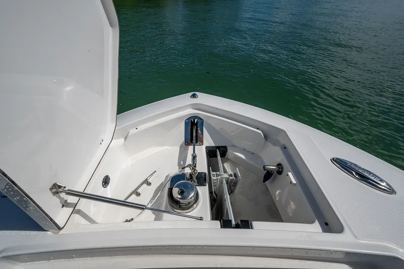 Aurora Yacht Photos Pics 2019 Blackfin 332 boat anchor compartment with open hatch, on calm water.