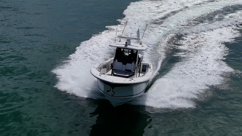 Aurora Yacht Photos Pics 2019 Blackfin 332 boat cruising on open water, creating a dynamic wake.