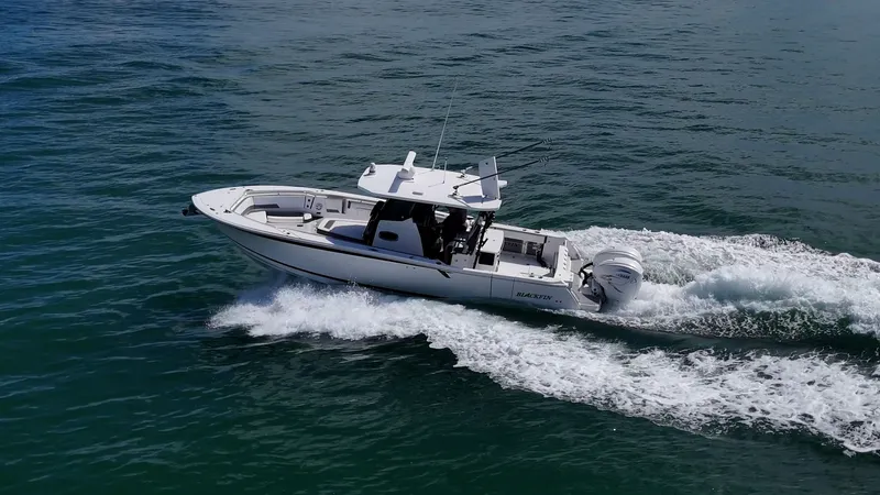 Aurora Yacht Photos Pics 2019 Blackfin 332 boat cruising on open water, creating a wake.