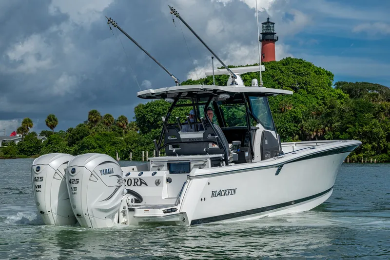 Aurora Yacht Photos Pics 2019 Blackfin 332 boat with twin Yamaha 425 engines near a lighthouse.