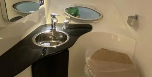 Ready For Immediate Delivery Yacht Photos Pics 2025 Hanover 305 Outboard T-Top Edition interior with sink and porthole window.